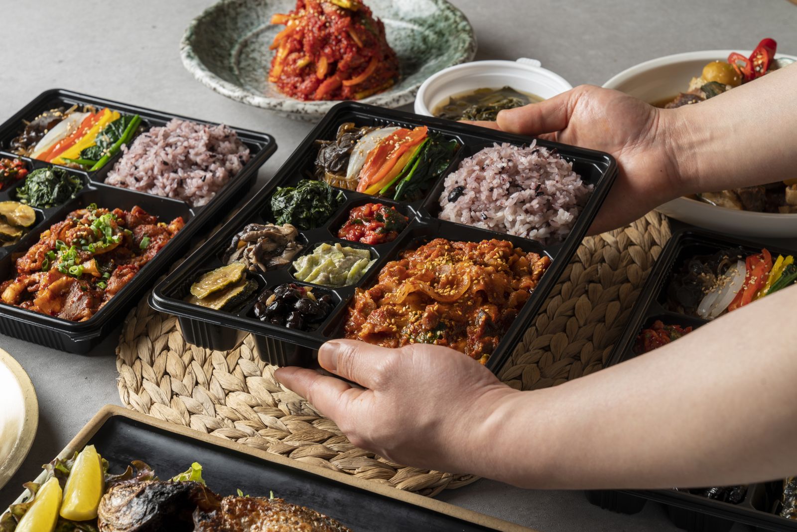Korean dosirak boxes with purple rice, spicy pork and banchan